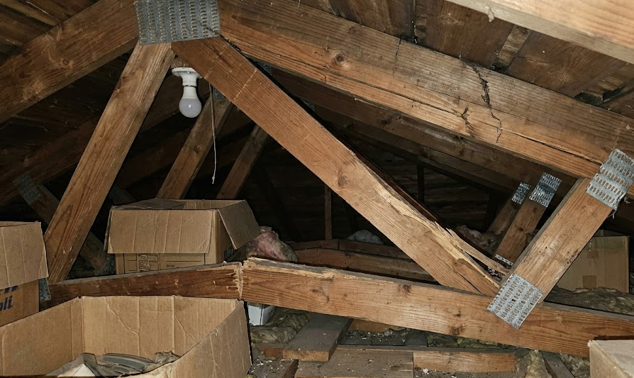 Structural engineer inspecting improperly modified cracked truss in Virginia