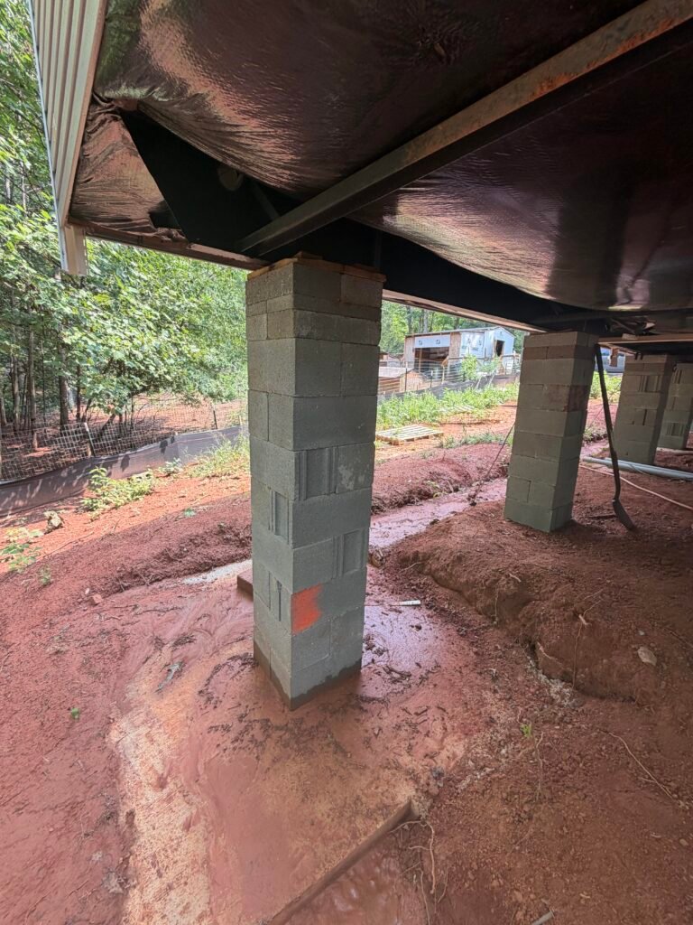 Tall dry-stacked block pier with multiple visible issues