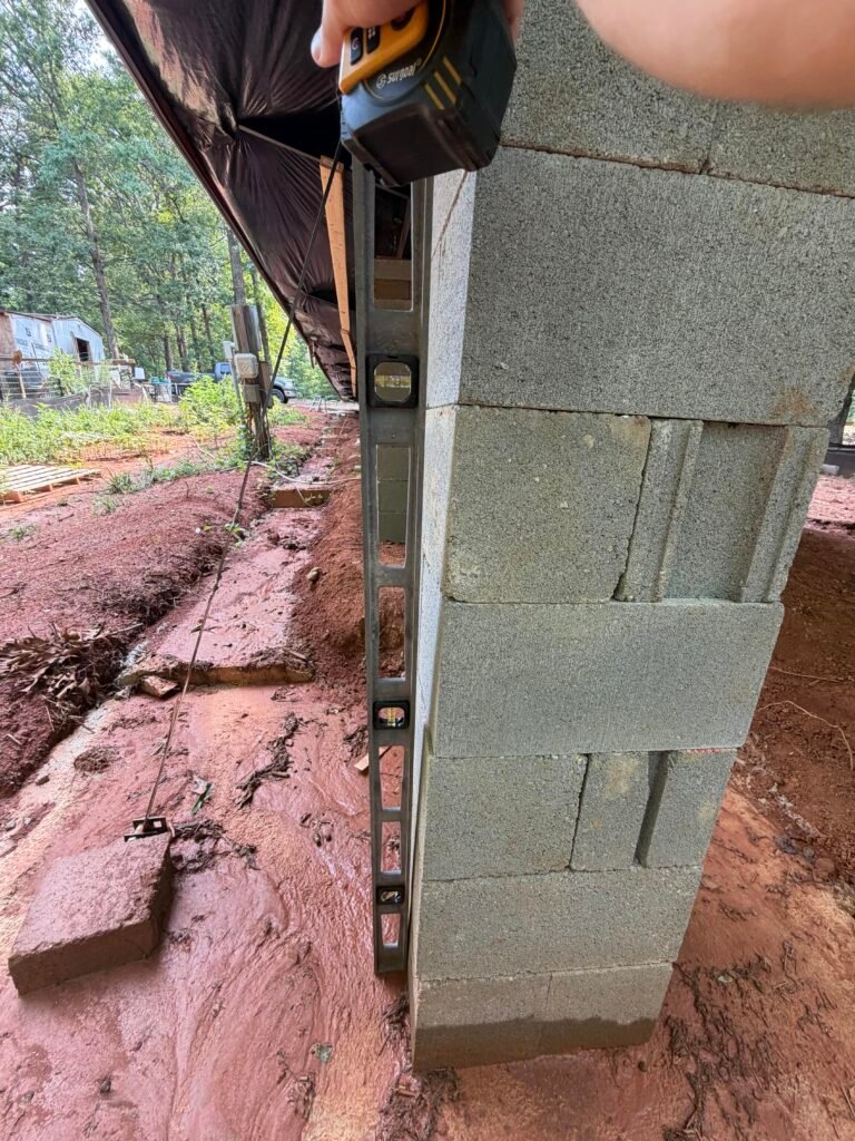 Leaning dry-stacked block pier that is out of plumb