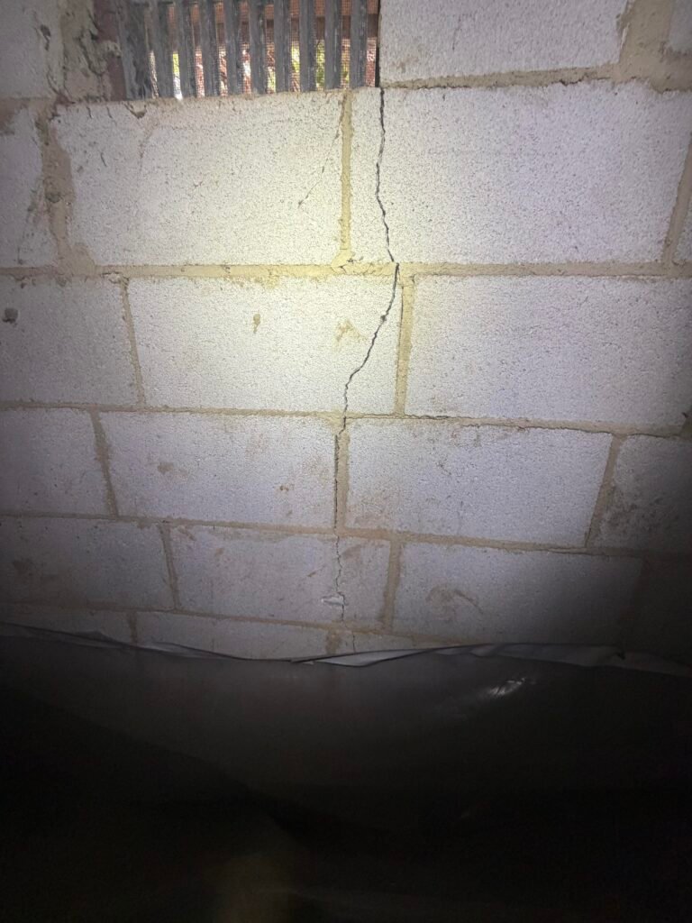 Foundation wall crack viewed from inside a crawlspace