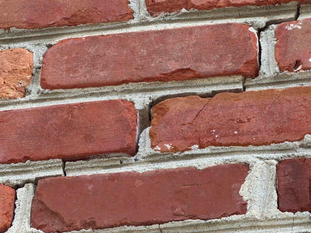 Stair-step crack running through the mortar joints of a masonry wall