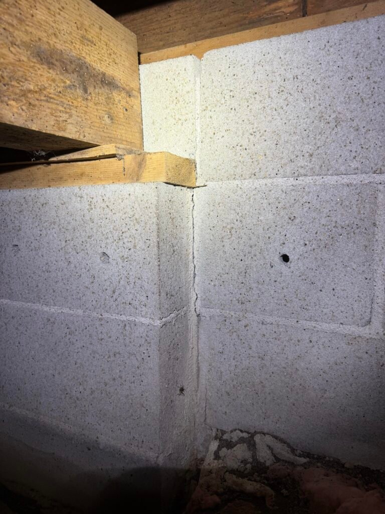 Cracked masonry pilaster under a girder that is not fully bearing