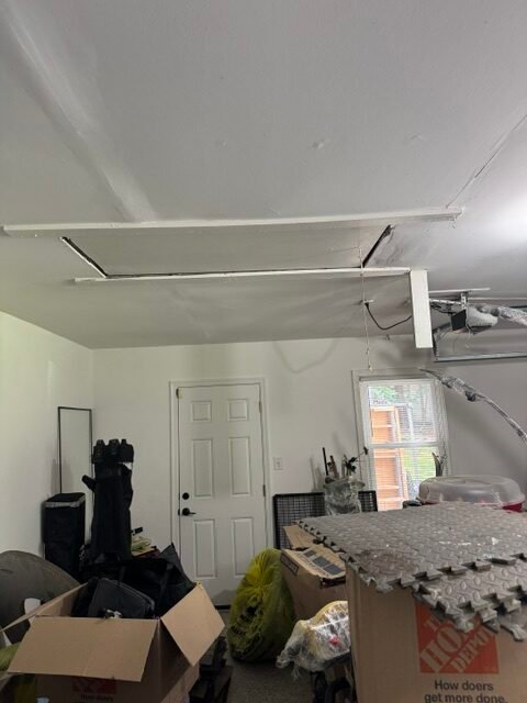 Makeshift pull-down stairs leading from a garage to the attic