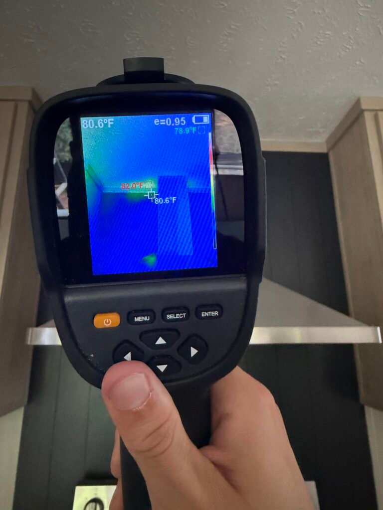 Thermal imaging camera being used to check a surface for temperature differences